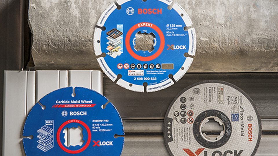 Three Bosch XLOCK cutting discs are lying on a gray background.