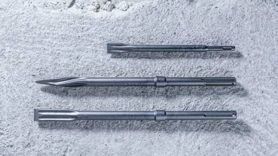 Three gray Bosch Professional tool attachments are lying on concrete floor.