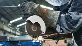 A person is cutting metal with a Bosch Professional cutting disc.