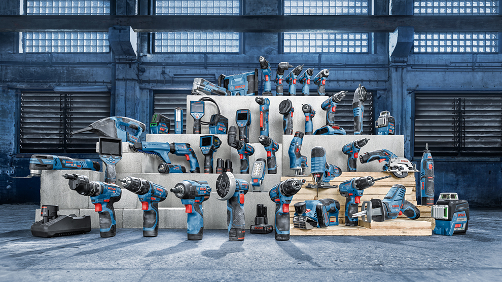 Various Bosch Professional tools on wooden pallets and concrete.