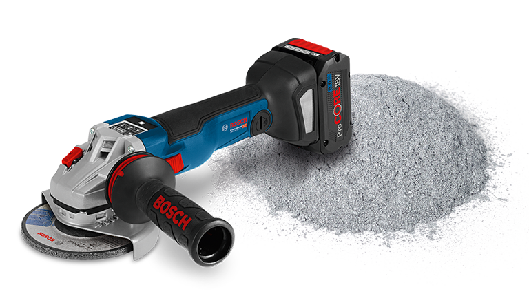 A blue Bosch Professional angle grinder is lying next to gray dust.