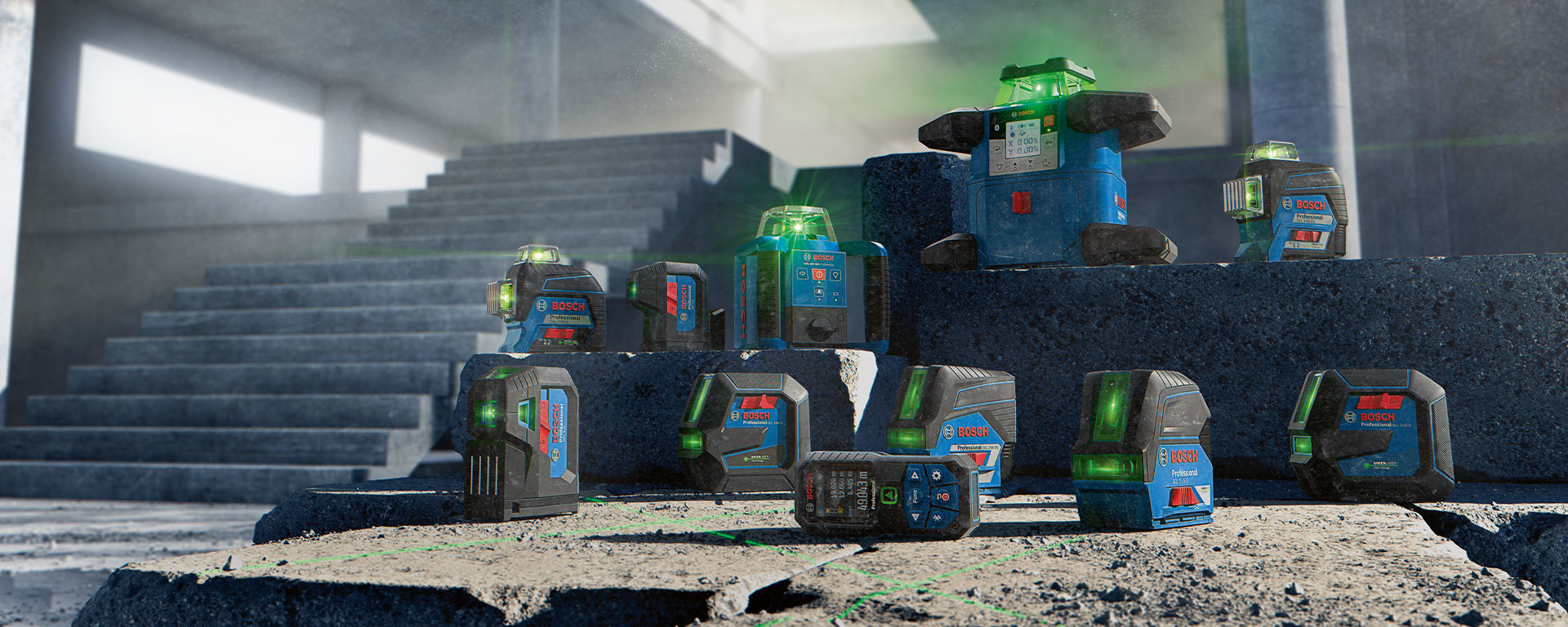 Several Bosch Professional laser devices on a concrete surface.