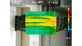 Thermographic image with green and yellow temperature indicators from cables.