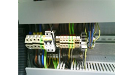 An electrical cabinet with colorful cable connections.