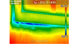 Thermographic image of a wall with a color gradient from blue to red.