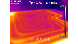Thermographic image shows temperature variation with colorful tones.