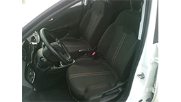Two black sports seats and a steering wheel in a white car.