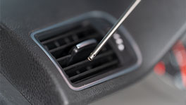 A tool is gripping into a car's air outlet.