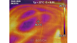 Thermographic image shows temperature distribution in orange and purple tones.