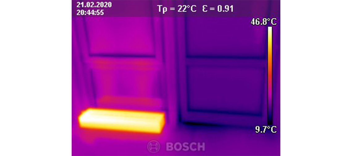 Thermographic image with a warm area in front of a door.